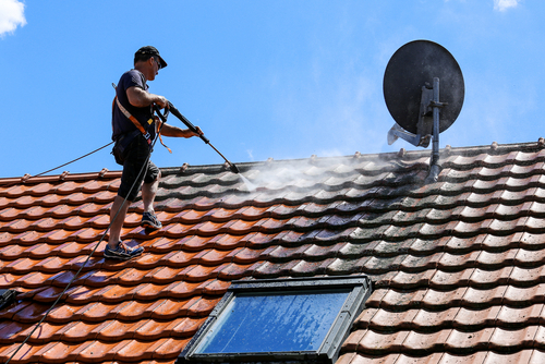 power washing a roof of a home