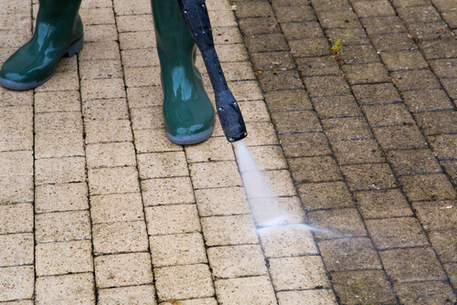 power washing the pathways of a home